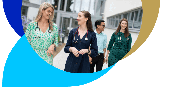 Group of doctors walking outside hospital building